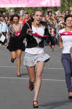 Running in heels. 2012 (looks: grey mini skirt, white top, black sport jacket, )