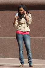 Красуні-іноземки на столичному проспекті (наряди й образи: сіні джинси, бежевий жакет, топ кольору фуксії, різнокольорові босоніжки)