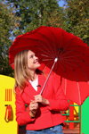 Natalia Vodianova. Photofact. Natalia Vodianova (looks: red blazer, red umbrella)