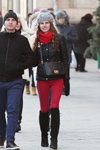 Minsk street fashion. 12/2014 (looks: blue jeans, suede black boots, red scarf, black bag, red trousers, grey knit cap with pom-pom, black quilted jacket)