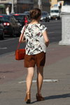 Minsk street fashion. 08/2015 (looks: brown wedge pumps, brown shorts, red bag, printed blouse)