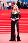 Closing ceremony — 39th MIFF (looks: blackevening dress with slit, black clutch, black sandals, blond hair)