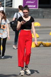 Hot May 2018. Street fashion in Minsk (looks: black top, red trousers)