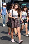 Gorący maj 2018. Moda uliczna w Mińsku (ubrania i obraz: top z nadrukiem biały, torebka czarna, spódnica w szkocką kratę czarna)