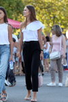Street fashion. 08/2019 (looks: white top, black trousers, pink bag)
