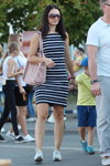 Street fashion. 08/2019 (looks: striped fitted black and white dress, pink bag, white sneakers)