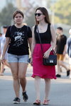 Street fashion. 08/2019 (looks: black printed top, grey shorts, blacksneakers, black top, fuchsia skirt, black bag, red sandals)