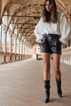 MOHITO FW 19/20 campaign (looks: white blouse, black boots, black leather shorts)