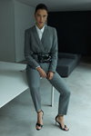 Modern office. MOHITO FW 19/20 campaign (looks: grey pantsuit, black sandals, white blouse)
