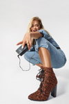 Rita Ora. ShoeDazzle x Rita Ora campaign (looks: sky blue denim jumpsuit, brown ankle boots with leopard print, blond hair)