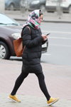 Minsk street fashion. 02/2020 (looks: black tights, yellow sneakers, black quilted coat)