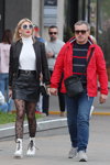 Minsk street fashion. 05/2020. Part 2 (looks: black leather jacket, , black belt, black mini leather skirt, black fantasy tights, white lowboots, blond hair, Sunglasses, red jacket)