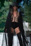 Amoralle lingerie show — Riga Fashion Week SS2022 (looks: nude transparent bodysuit, black knee high boots, black stockings, black hat)