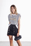Odi et Amo SS 2021 lookbook (looks: white striped top, black mini skirt, black clutch)