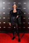 Гості — Riga Fashion Week SS23 (наряди й образи: чорний топ, чорна шкіряна спідниця міні, чорні колготки, чорні чоботи-панчохи)