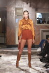 UNATTACHED show — Riga Fashion Week SS23 (looks: red large mesh tights, brown shorts, brown boots)