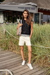 Betty Barclay SS 2022 campaign (looks: white shorts, white sneakers, black top)