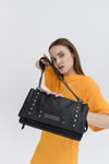 Clio Goldbrenner FW22 campaign (looks: orange pullover dress, black bag)