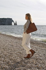 Tamaris FW 2021 campaign (looks: striped black and white jumper, white trousers, brown bag, brown lowboots)