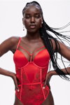Share the Joy. Victoria's Secret Holiday Edit 2022 lingerie campaign (looks: red guipure bodysuit)