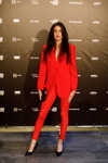 Guests — Riga Fashion Week AW23/24 (looks: black pumps, red pantsuit, black clutch)